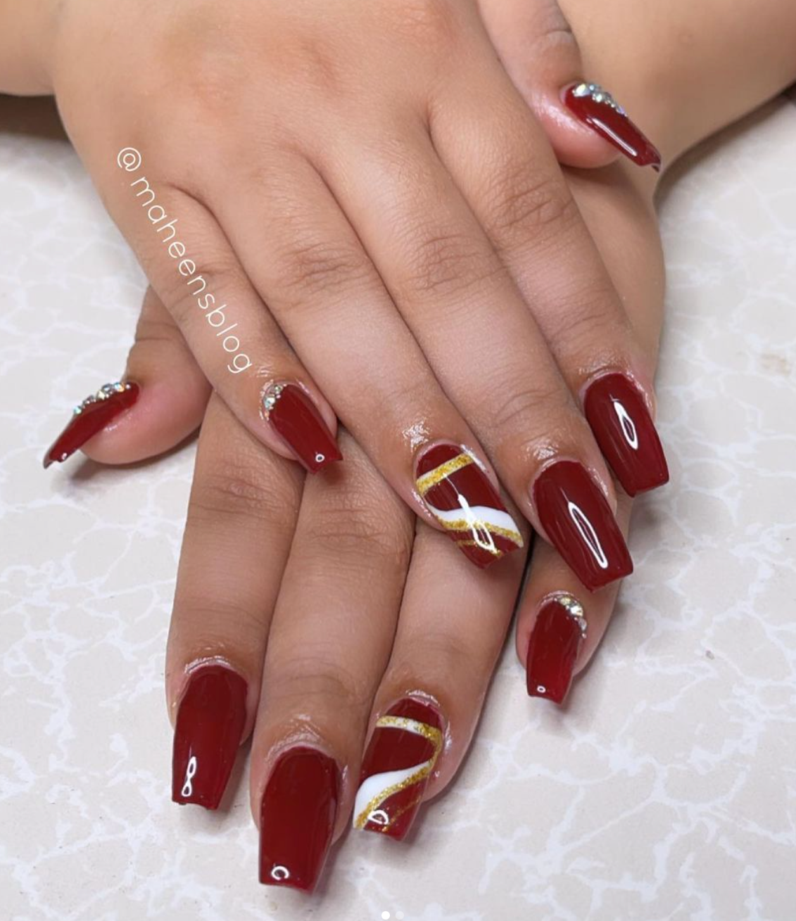 Maroon Nails with stripes and crystals